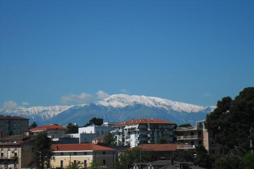 a city with snow capped mountains in the background at Albergo Roma in Lanciano