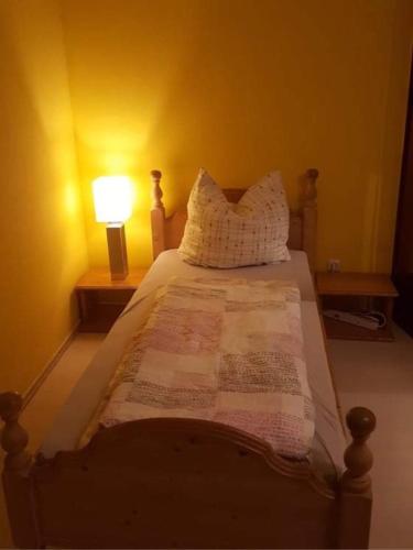 a bedroom with a bed with a lamp on it at Am-Berg Ferienwohnung in Bad kohlgrub in Bad Kohlgrub