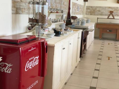 a kitchen with an old cocacola refrigerator in a kitchen at Hotel Rabay in Brenzone sul Garda