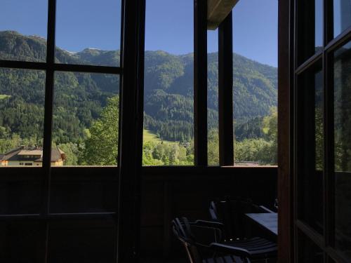 a room with a view of mountains through windows at Appartements Rosenstockl in Gundersheim