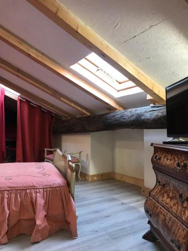 a bedroom with a bed and a tv in a room at Sanctus Syrus 2 in Albenga
