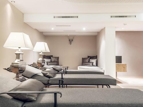 a room with three beds and a couch at GEBHARD Boutique B&B inklusive Sommercard in Fiss
