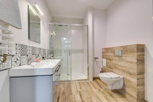 a bathroom with a toilet and a sink and a shower at Green Apartments Katowice Chorzów in Chorzów