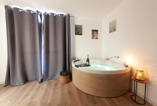 a bathroom with a tub with a shower curtain at Palazzo Lombardi Al Vicolo in Sassari
