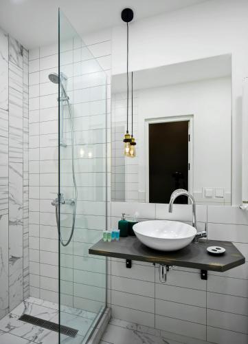 a bathroom with a sink and a glass shower at Kantar Hotel in Yerevan