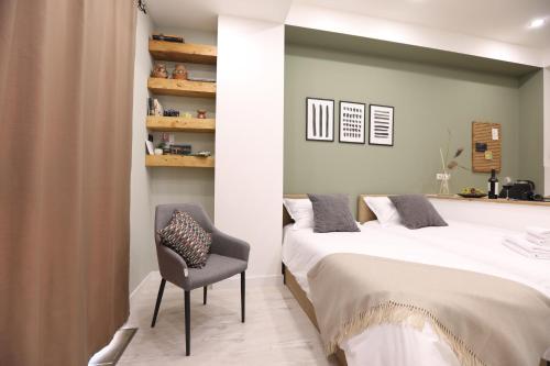 a bedroom with a bed and a chair at hotelise I Bells-Of-Ireland Apartment in Yerevan