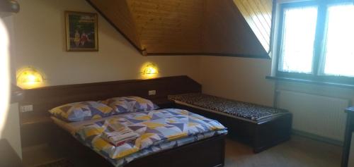 Wynajem Pokoi Osada في فواديسوافوفو: غرفة نوم فيها سرير ومقعد