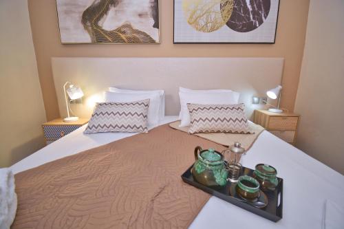 a bedroom with a bed with a tray on it at Villa Marinos in Kavos