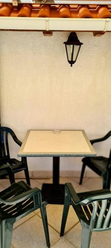 a table and two chairs in a room at Bed & Breakfast Dionis Vis in Vis