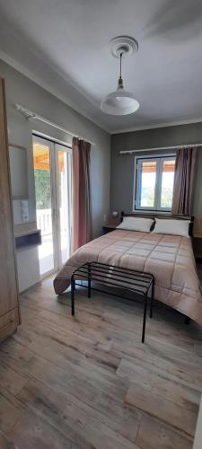 a bedroom with a large bed and a large window at Villa Bella Vista in Marathias