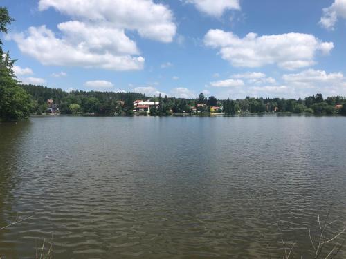 a large lake with a house in the middle of it at Apartmány Jevany in Jevany