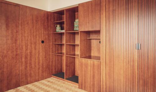 a room with wood paneled walls and shelves at Ceuta Terrace Suites in Porto