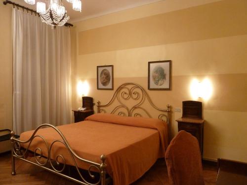 a bedroom with a bed with an orange blanket at Hotel Antica Dogana in Turin