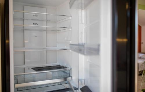 a refrigerator with empty shelves in a room at Apartments Luka in Rab