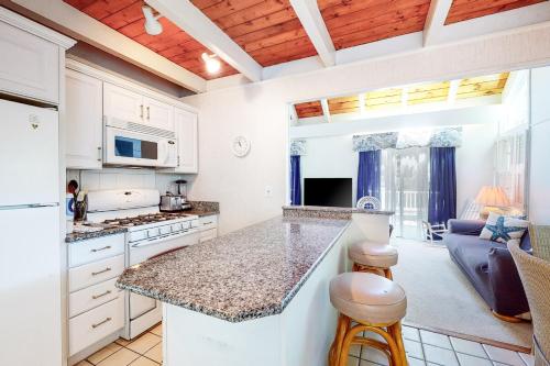 a kitchen with white cabinets and a counter top at Summersea in Mashpee