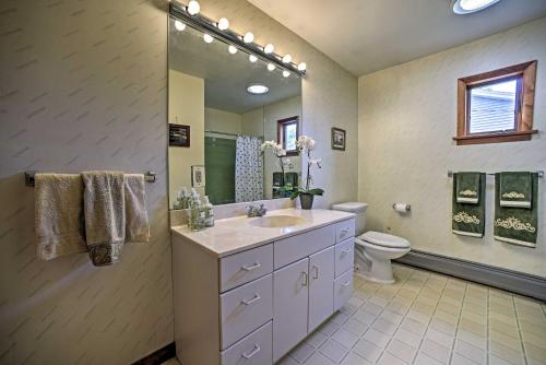 a bathroom with a sink and a toilet and a mirror at Lakeside Berkshires Home Near Hiking and Skiing! in Lanesborough