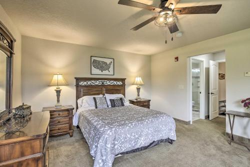 a bedroom with a bed and a ceiling fan at Lakefront Birchwood Condo with Pool and Hot Tub! in Birchwood