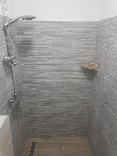 a bathroom with a shower with a glass door at Ana ROOMS in Ljubuški