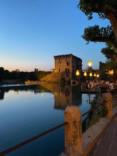 a castle in the middle of a lake at night at Casacobelli in Monzambano