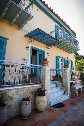 a house with blue doors and a balcony at Acronafplia Pension A in Nafplio