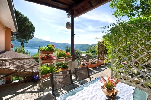 a patio with a table and chairs and flowers at Villalbert in Castel Gandolfo