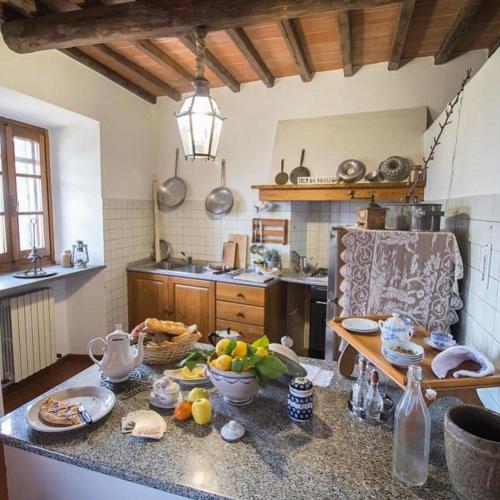 a kitchen with a counter with bowls of food on it at La Magione dei Todaro in Borgo a Buggiano