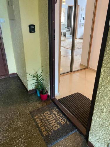 an open door with a welcome mat in a hallway at Vicky - New Apartment Centrum Srodmiescie in Warsaw