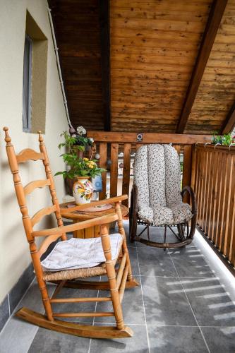 a rocking chair and a chair on a porch at Golden BIS, Subotica in Subotica
