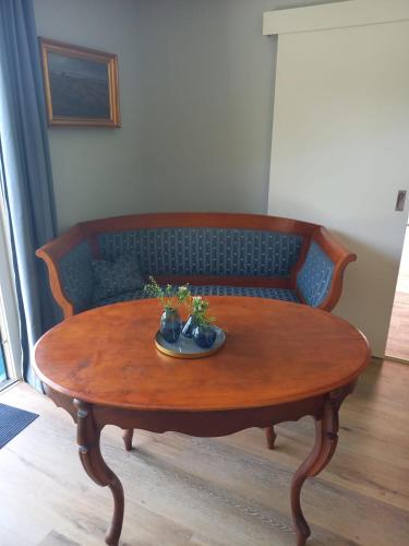 a wooden table with a plate on top of it at Schooster Huus in Nordstrand