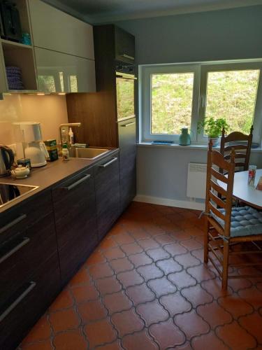 a kitchen with a table and a chair in it at Schooster Huus in Nordstrand