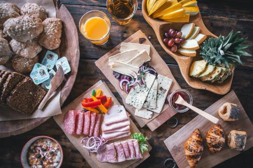 a wooden table with different types of food and drinks at Sonnerupgaard Hotel & Konference in Kirke-Hvalsø