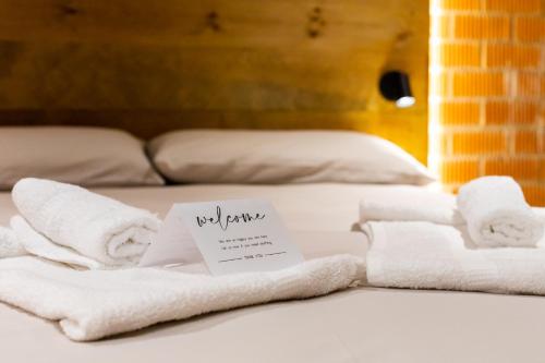 a pile of towels sitting on top of a bed at ART LOFTS Valencia by Benisur in Valencia