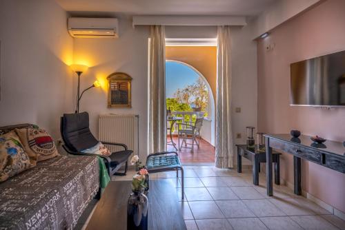 a living room with a couch and a table at Boutique Seafront Suites in Zakynthos Town