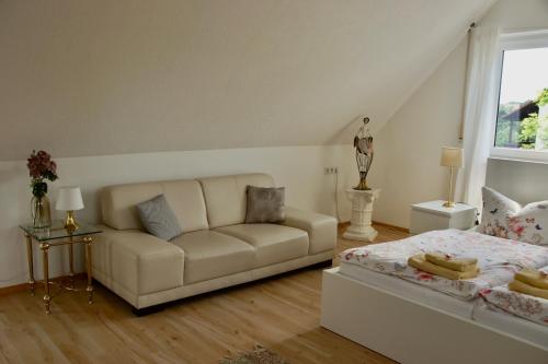 a living room with a couch and a bed at Karuna Haus in Bad Windsheim