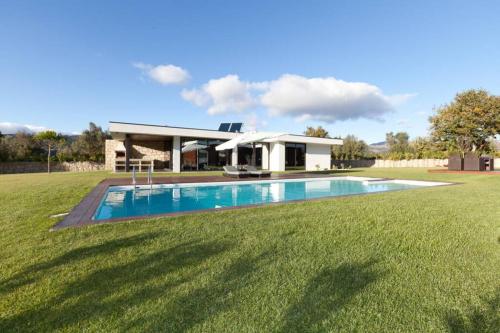 a house with a swimming pool in a yard at Casa de Louredo-Gerês in Vieira do Minho