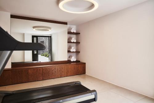 a living room with a fireplace and a mirror at Orama Hotel & Spa in Fira