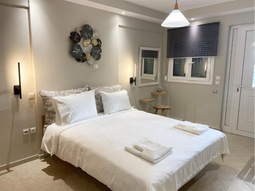 a bedroom with a large white bed with balloons on the wall at Sea & Sky by Marisa in Petrokhorion