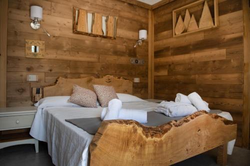 a bedroom with a bed with towels on it at L'Arbergh Palanfrè in Vernante