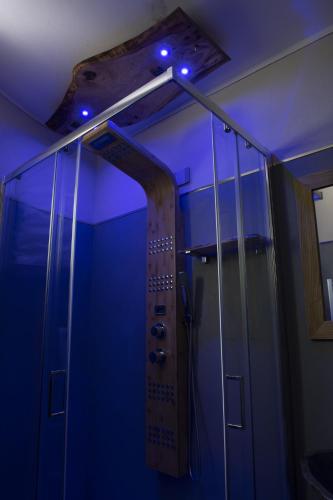 a shower with blue lights in a bathroom at L'Arbergh Palanfrè in Vernante