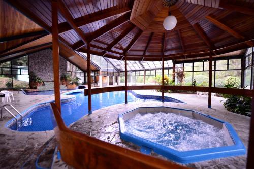 a large swimming pool with a hot tub in a building at Hotel Bambito Resort by Faranda Boutique in Cerro Punta