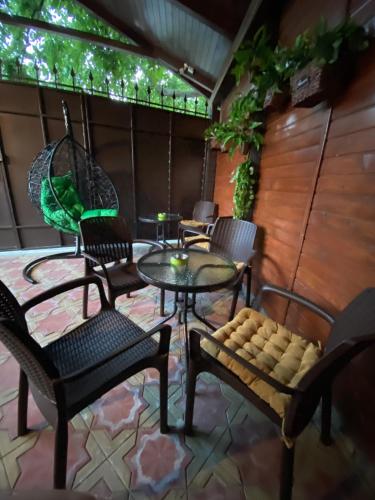 a patio with chairs and a table and a swing at Апартаменты Три Стиля у Цветника in Pyatigorsk