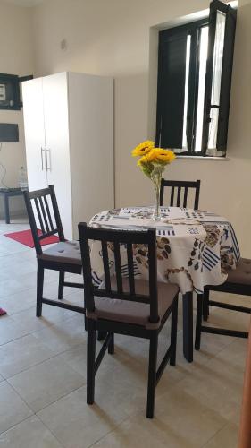 a table with a vase of flowers on top of it at Casa Vacanze Le CIsterne in Gioia Tauro