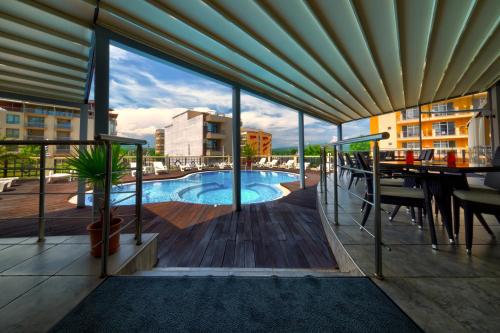 a view from the balcony of a hotel with a swimming pool at хотел Свети Николай Приморско in Primorsko