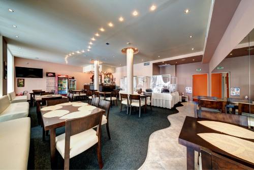 a restaurant with tables and chairs in a room at хотел Свети Николай Приморско in Primorsko