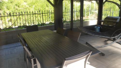 a table and chairs on a screened in porch at siros in Iron