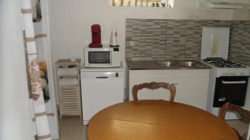 a small kitchen with a table and a microwave at siros in Iron