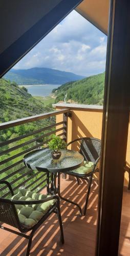 ein Tisch und Stühle auf einem Balkon mit Aussicht in der Unterkunft Filip Apartment in Mavrovo-Nationalpark