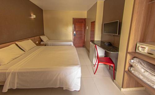 Ένα ή περισσότερα κρεβάτια σε δωμάτιο στο Safira Praia Hotel
