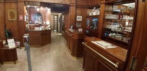 a room with wooden walls and a bar with glasses at Hotel Domizil in Vienna