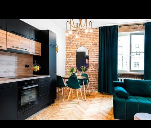 a living room with a couch and a table with chairs at Heart of the Old WROCLOVE in Wrocław